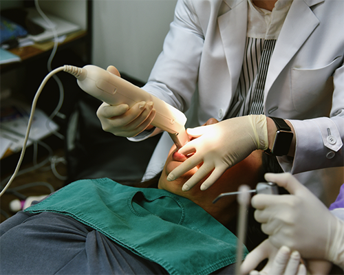 Dentist capturing close-up photos of a patient's mouth