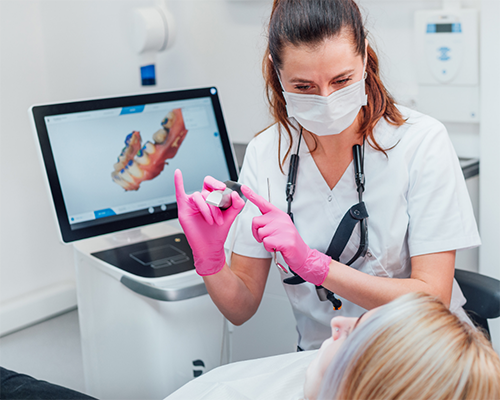 Dental professional showing a small device to a patient