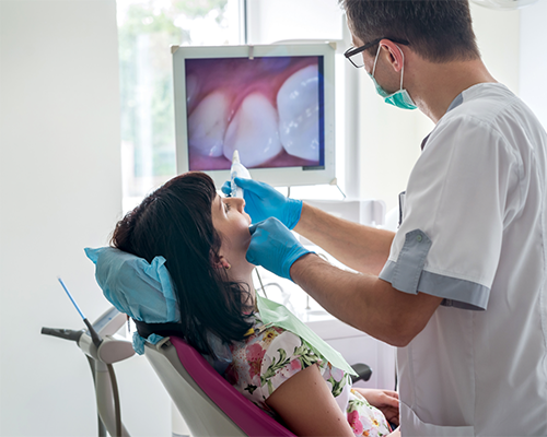 Dentist taking close-up photos of a patient's teeth