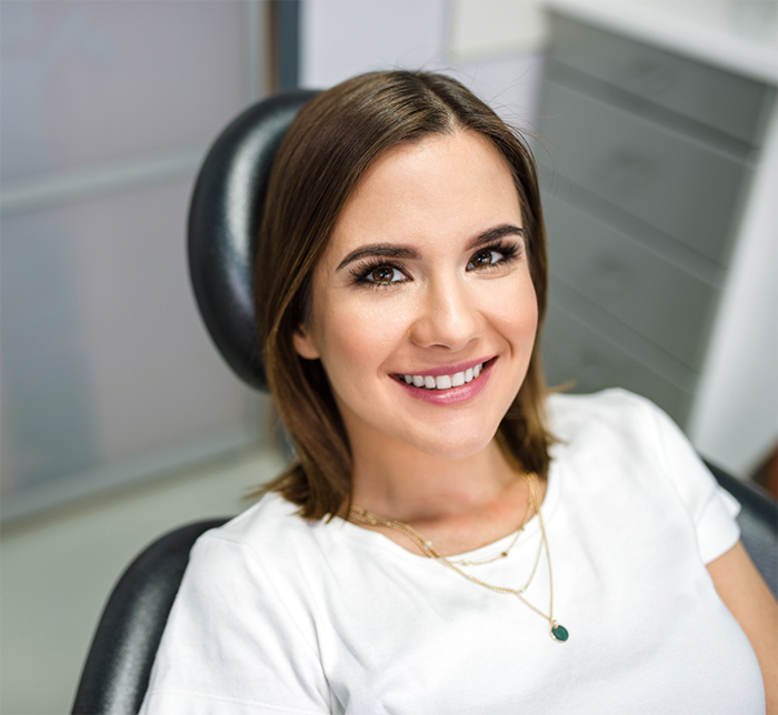 Young woman smiling in the dental chair