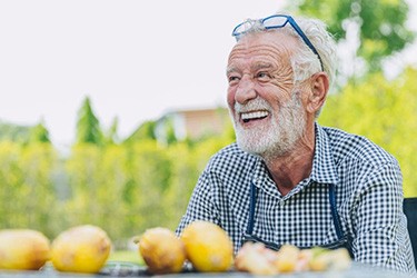 Man smiles at picnic table