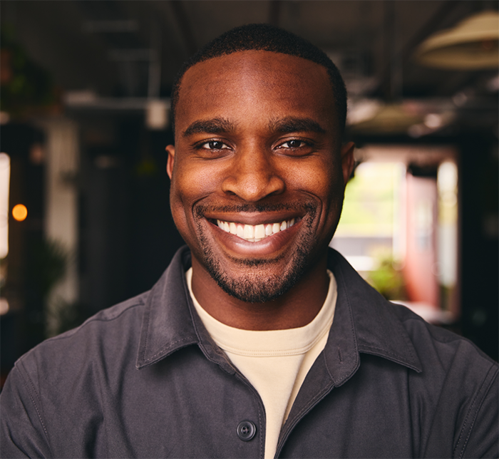Man smiling confidently after a cosmetic gum lift in North Dallas