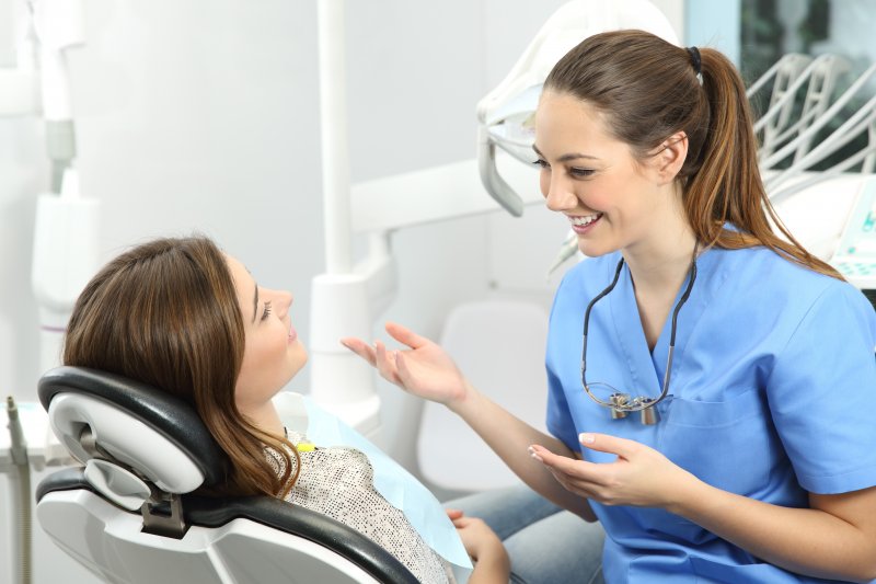 dentist talking to patient about dental implants